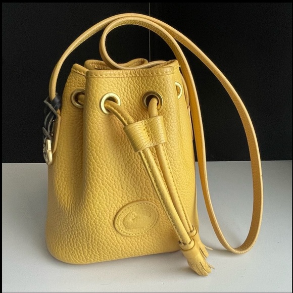 Dooney & Bourke Handbags - Dooney and Bourke AWL leather Palomino Yellow mini drawstring bucket bag purse